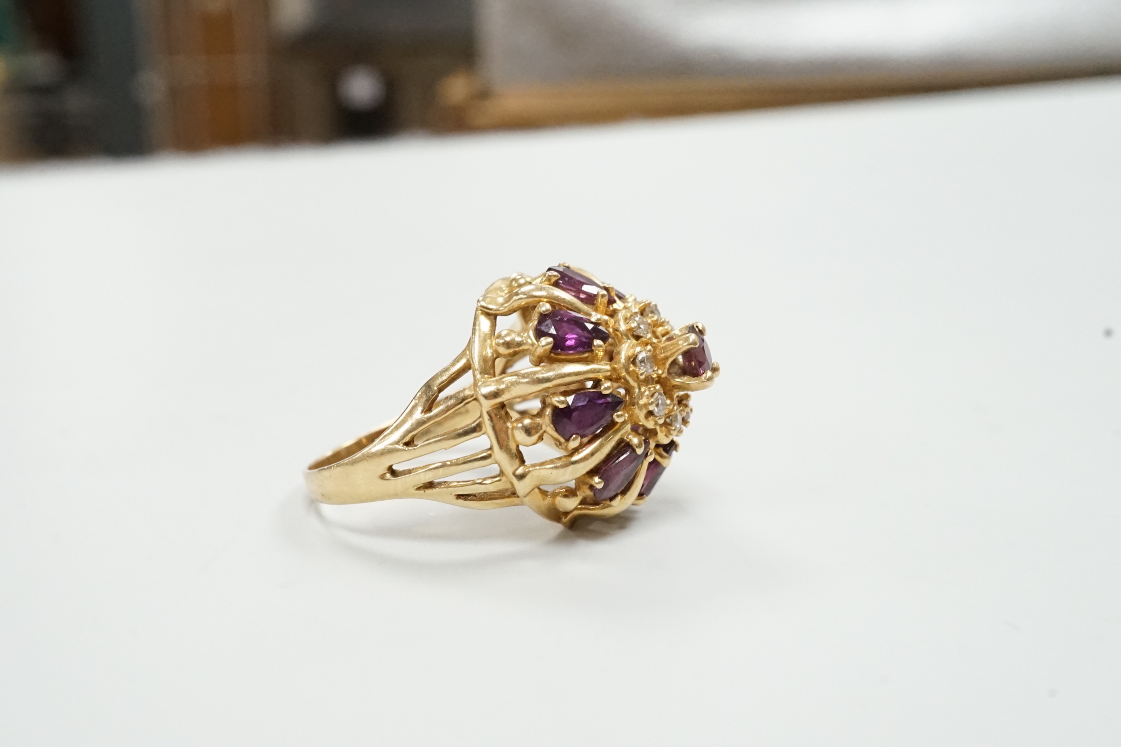 A modern 14ct gold, amethyst? and diamond chip cluster set domed dress ring, size M, gross weight 7.2 grams.